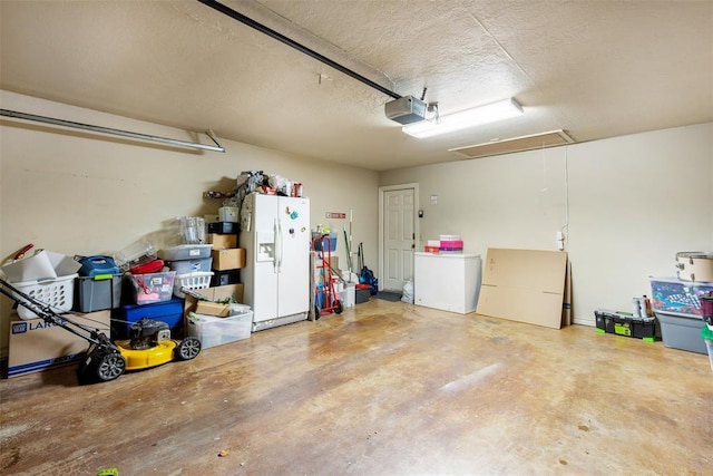 817 NW 76th St, Lawton, OK 73505 - garage with white refrigerator with ice dispenser, a garage door opener, and refrigerator