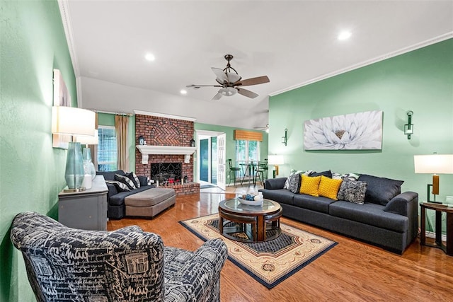 817 NW 76th St, Lawton, OK 73505 - living area with crown molding, a ceiling fan, wood finished floors, a brick fireplace, and recessed lighting