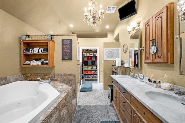 817 NW 76th St, Lawton, OK 73505 - bathroom with double vanity, a jetted tub, tile patterned floors, a chandelier, and a textured wall