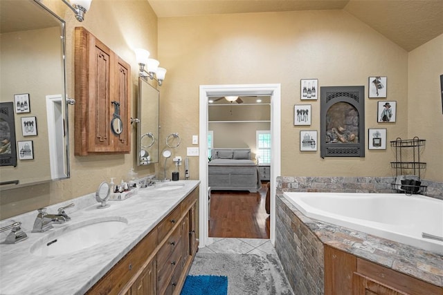 817 NW 76th St, Lawton, OK 73505 - ensuite bathroom with a garden tub, double vanity, tile patterned floors, and vaulted ceiling