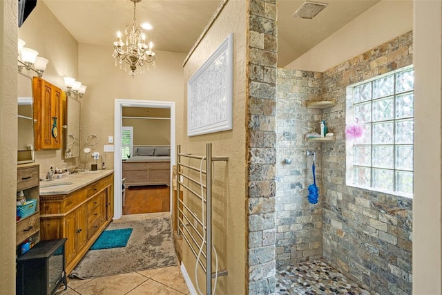 817 NW 76th St, Lawton, OK 73505 - ensuite bathroom with a chandelier, walk in shower, double vanity, and tile patterned floors