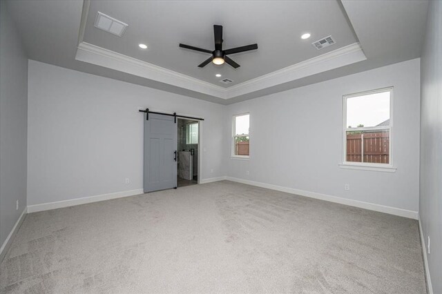 1890 E Industrial Rd, Guthrie, OK 73044 - unfurnished bedroom with a raised ceiling, ornamental molding, a barn door, carpet flooring, and recessed lighting