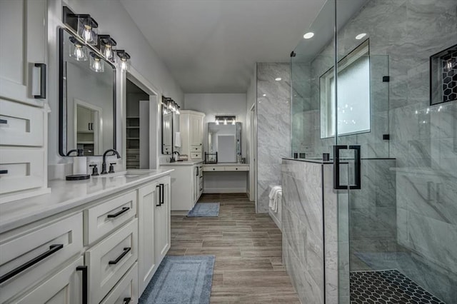 1890 E Industrial Rd, Guthrie, OK 73044 - full bathroom featuring a marble finish shower, two vanities, and wood finished floors