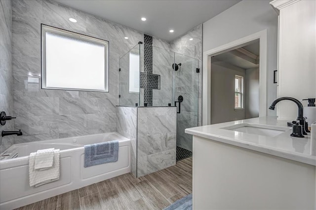 1890 E Industrial Rd, Guthrie, OK 73044 - full bathroom featuring a garden tub, a marble finish shower, vanity, wood finished floors, and recessed lighting