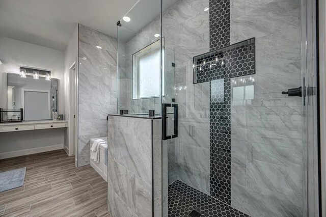 1890 E Industrial Rd, Guthrie, OK 73044 - full bathroom with a shower stall, wood finished floors, vanity, and a tub to relax in