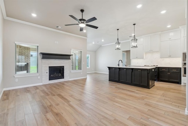 3621 NW 190th St, Edmond, OK 73012 - kitchen featuring white cabinets, ornamental molding, light countertops, dark cabinets, and a ceiling fan