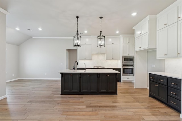 3621 NW 190th St, Edmond, OK 73012 - kitchen featuring stainless steel appliances, white cabinets, light countertops, dark cabinetry, and recessed lighting