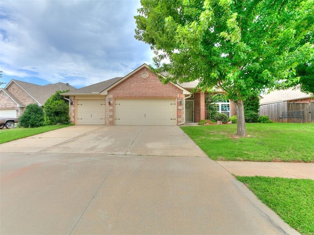 1205 NW 190th Pl, Edmond, OK 73012 - view of front facade featuring a garage, concrete driveway, and brick siding