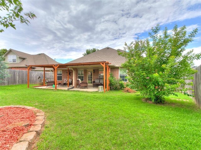 1205 NW 190th Pl, Edmond, OK 73012 - rear view of property featuring a patio area, a fenced backyard, and brick siding