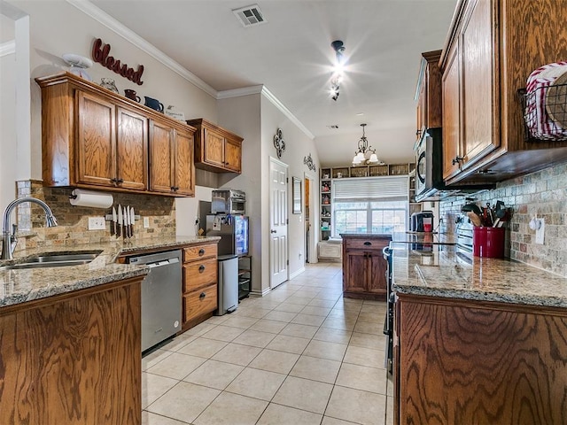 1205 NW 190th Pl, Edmond, OK 73012 - kitchen with stainless steel appliances, tasteful backsplash, brown cabinetry, light tile patterned flooring, and crown molding