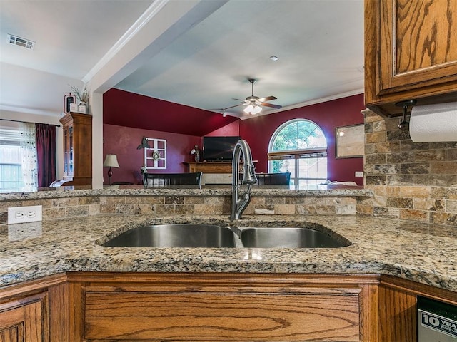 1205 NW 190th Pl, Edmond, OK 73012 - kitchen featuring ceiling fan, brown cabinets, stone countertops, and dishwashing machine