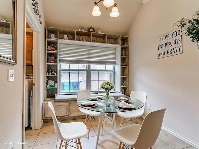 1205 NW 190th Pl, Edmond, OK 73012 - dining area featuring light tile patterned floors, lofted ceiling, a chandelier, and washer / clothes dryer