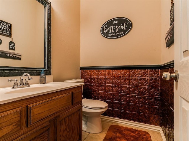 1205 NW 190th Pl, Edmond, OK 73012 - bathroom featuring vanity, tile patterned floors, a wainscoted wall, and tile walls