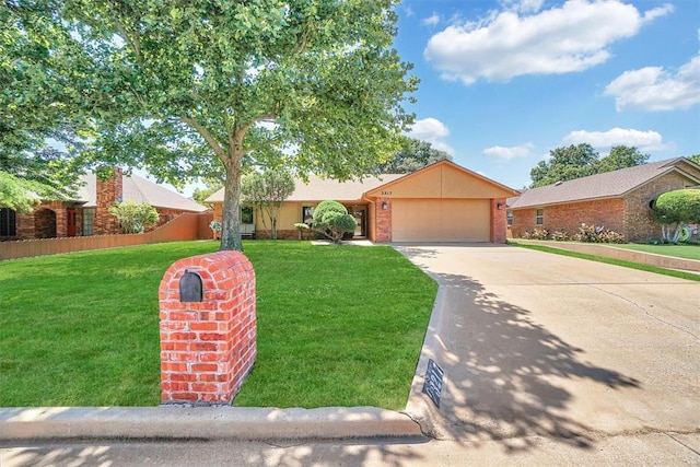 3217 Quail Cir, Altus, OK 73521 - view of front of house with concrete driveway, a garage, a front yard, and brick siding