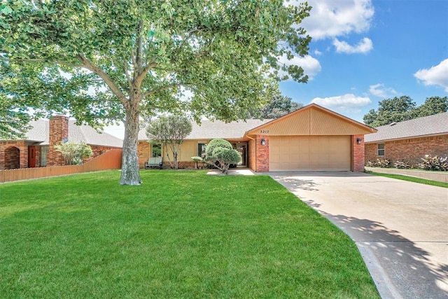 3217 Quail Cir, Altus, OK 73521 - view of front of property with an attached garage, brick siding, concrete driveway, and a front lawn