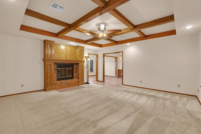 3217 Quail Cir, Altus, OK 73521 - unfurnished living room with coffered ceiling, light carpet, a fireplace, a ceiling fan, and beamed ceiling