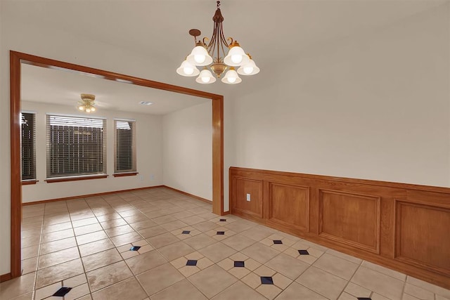 3217 Quail Cir, Altus, OK 73521 - empty room featuring light tile patterned floors, a chandelier, and ceiling fan