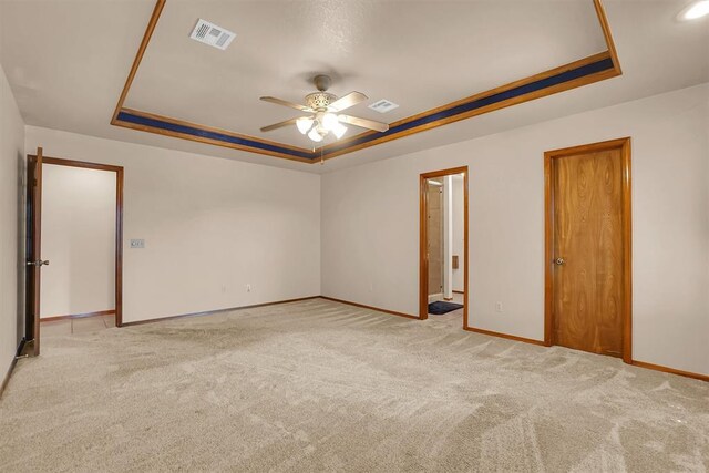3217 Quail Cir, Altus, OK 73521 - empty room featuring a tray ceiling, ceiling fan, and carpet