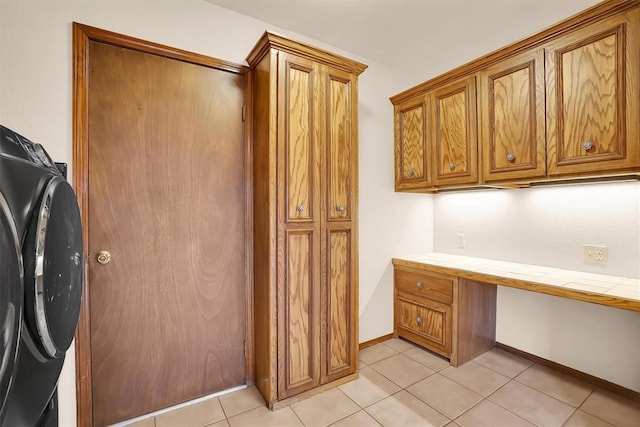 3217 Quail Cir, Altus, OK 73521 - laundry area featuring washer / dryer, an office area, cabinet space, and light tile patterned floors