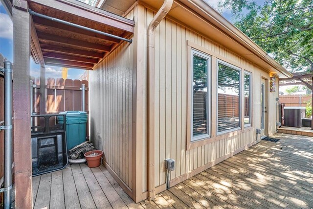 3217 Quail Cir, Altus, OK 73521 - view of side of home featuring a wooden deck and a central AC unit
