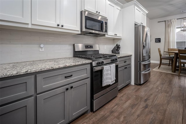 1540 17th Pl, Newcastle, OK 73065 - kitchen with stainless steel appliances, gray cabinetry, tasteful backsplash, and dark wood-type flooring