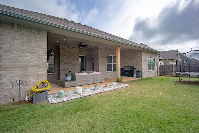 1540 17th Pl, Newcastle, OK 73065 - rear view of house featuring a trampoline, a ceiling fan, brick siding, outdoor lounge area, and a patio area