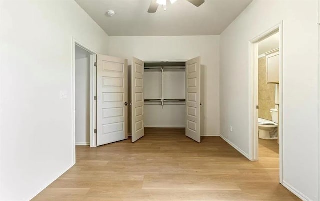 1426 SW Oklahoma Ave, Lawton, OK 73501 - unfurnished bedroom featuring a closet, light wood finished floors, ceiling fan, and ensuite bath