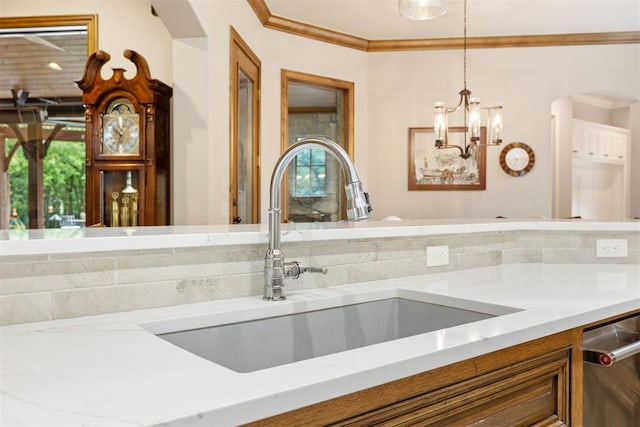 1605 Hidden Lake Dr, Edmond, OK 73034 - kitchen featuring stainless steel dishwasher, light stone counters, arched walkways, brown cabinetry, and ornamental molding