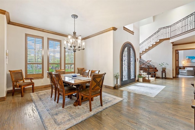 1605 Hidden Lake Dr, Edmond, OK 73034 - dining area featuring plenty of natural light, stairs, a chandelier, crown molding, and wood finished floors