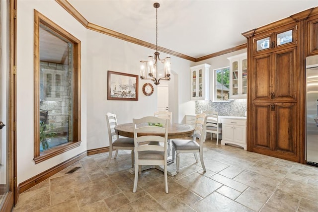 1605 Hidden Lake Dr, Edmond, OK 73034 - dining room with stone tile flooring, ornamental molding, and a chandelier