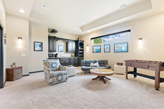 1605 Hidden Lake Dr, Edmond, OK 73034 - living room with a tray ceiling, light colored carpet, and recessed lighting