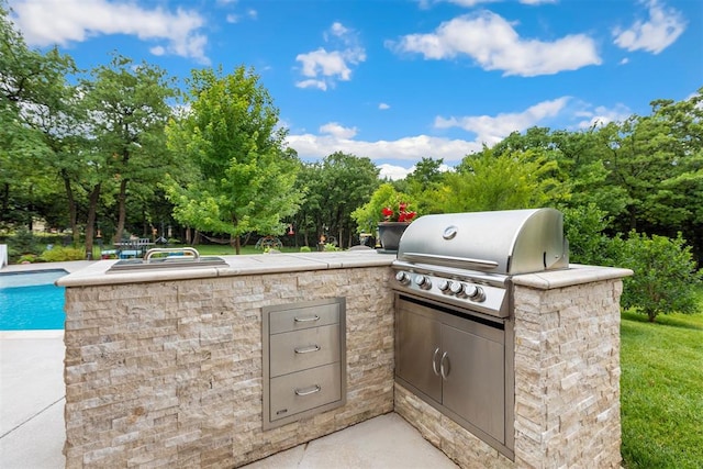 1605 Hidden Lake Dr, Edmond, OK 73034 - view of patio featuring area for grilling, an outdoor pool, and view of wooded area