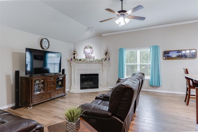 1604 Central Pkwy, Norman, OK 73071 - living area with light wood-style floors, a ceiling fan, vaulted ceiling, a fireplace, and crown molding