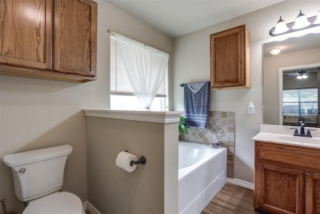 1604 Central Pkwy, Norman, OK 73071 - bathroom featuring a garden tub, vanity, wood finished floors, and ceiling fan