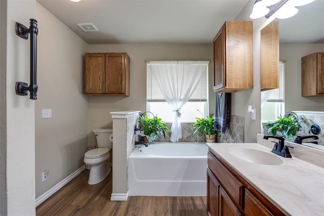 1604 Central Pkwy, Norman, OK 73071 - bathroom with plenty of natural light, a bath, vanity, and wood finished floors