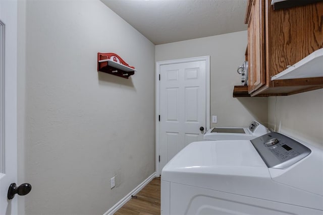 1604 Central Pkwy, Norman, OK 73071 - laundry room with cabinet space, washing machine and dryer, and wood finished floors