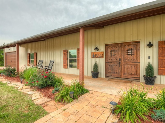 4920 W Forrest Hills Rd, Guthrie, OK 73044 - doorway to property featuring a garage and a porch