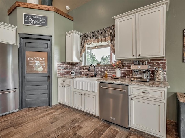 4920 W Forrest Hills Rd, Guthrie, OK 73044 - kitchen with stainless steel appliances, decorative backsplash, wood finished floors, and light stone countertops