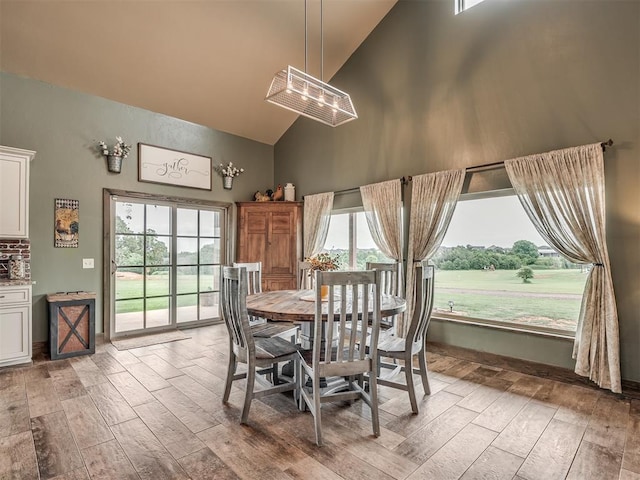 4920 W Forrest Hills Rd, Guthrie, OK 73044 - dining area featuring high vaulted ceiling, light wood-style flooring, and a chandelier
