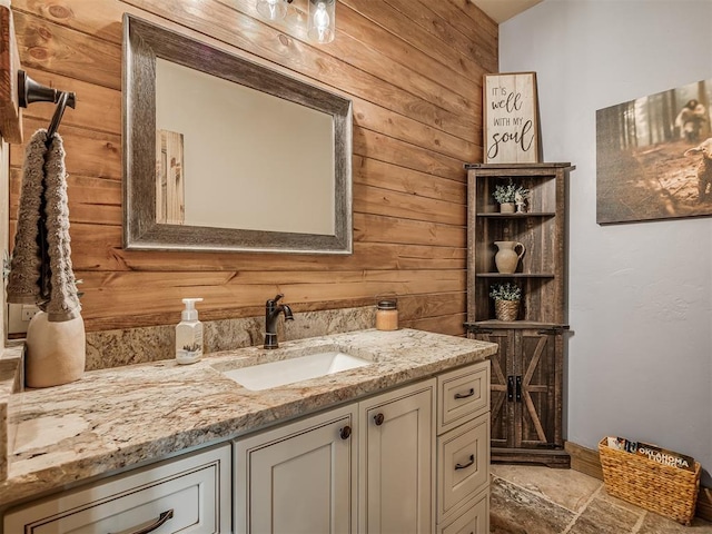 4920 W Forrest Hills Rd, Guthrie, OK 73044 - bathroom featuring wood walls, vanity, and stone finish flooring