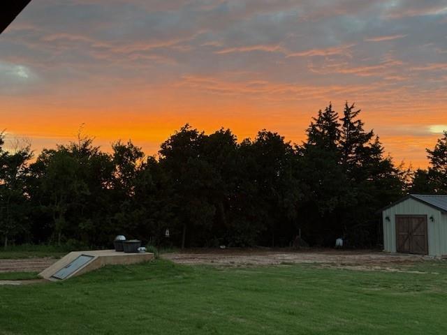 4920 W Forrest Hills Rd, Guthrie, OK 73044 - entry to storm shelter with a storage unit and a yard