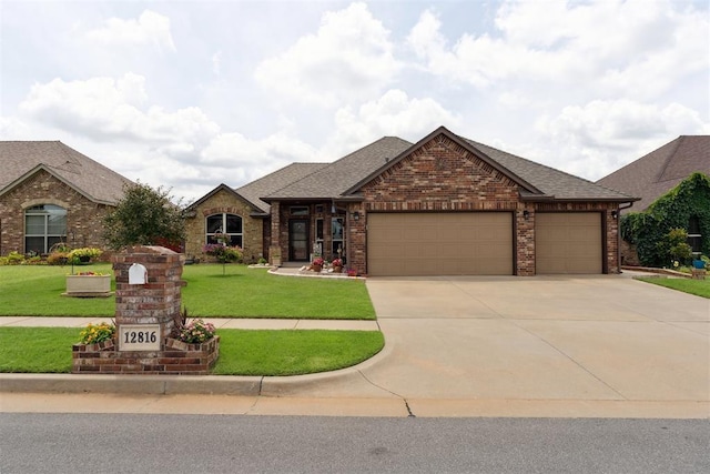 12816 NW 6th St, Yukon, OK 73099 - view of front facade with an attached garage, concrete driveway, brick siding, a front lawn, and roof with shingles