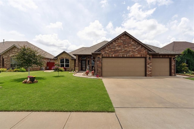12816 NW 6th St, Yukon, OK 73099 - view of front of house featuring a garage, a front lawn, brick siding, driveway, and a shingled roof