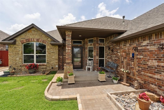 12816 NW 6th St, Yukon, OK 73099 - entrance to property with roof with shingles, a lawn, a patio, stone siding, and brick siding