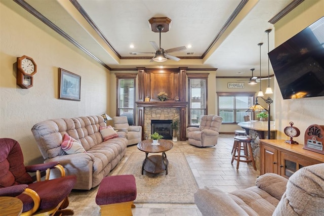 12816 NW 6th St, Yukon, OK 73099 - living area featuring healthy amount of natural light, a raised ceiling, ornamental molding, ceiling fan, and a fireplace