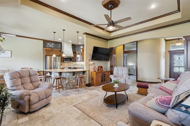 12816 NW 6th St, Yukon, OK 73099 - living area featuring ornamental molding, ornate columns, arched walkways, ceiling fan, and a raised ceiling
