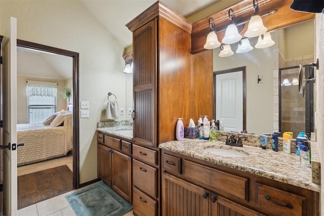 12816 NW 6th St, Yukon, OK 73099 - full bath with lofted ceiling, double vanity, ensuite bath, tile patterned flooring, and a tile shower