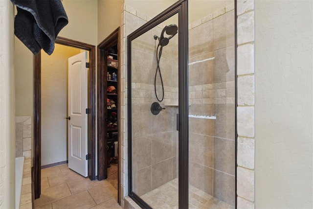 12816 NW 6th St, Yukon, OK 73099 - bathroom with a shower stall, tile patterned floors, and a walk in closet