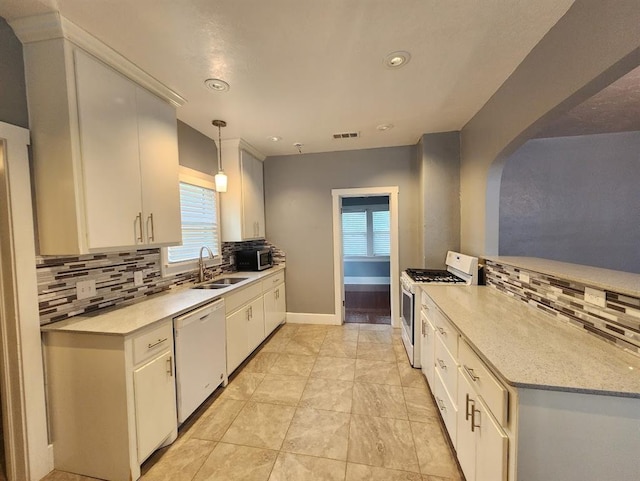 2719 NW 14th St, Oklahoma City, OK 73107 - kitchen featuring white appliances, light countertops, decorative backsplash, and recessed lighting