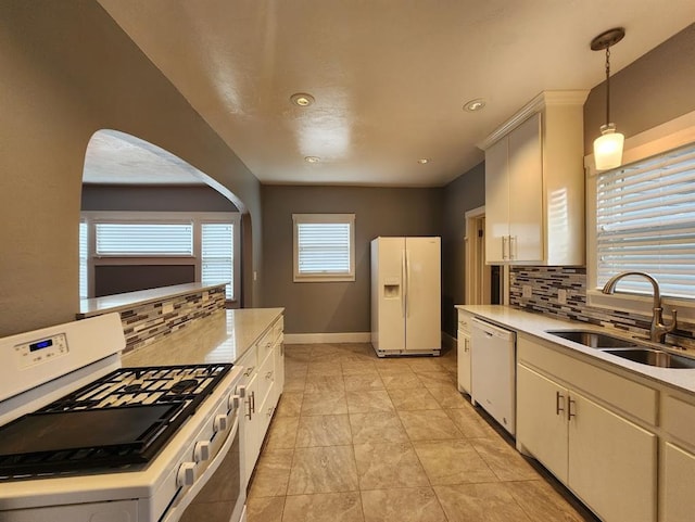 2719 NW 14th St, Oklahoma City, OK 73107 - kitchen with white appliances, tasteful backsplash, light countertops, recessed lighting, and pendant lighting